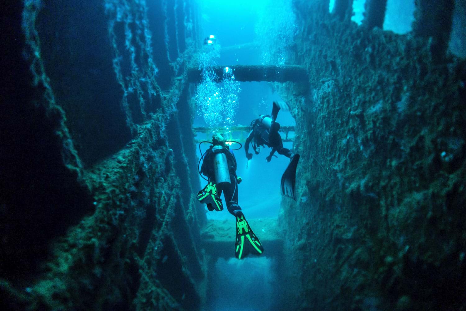 Divers exploring the underwater wreck of the SS President Coolidge, Santo