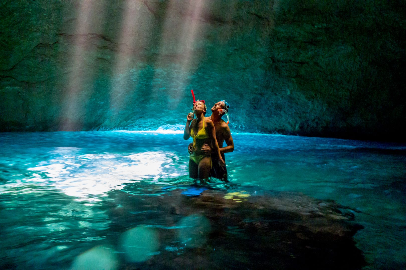 A couple snorkeling inside the Blue Cave, Tanna