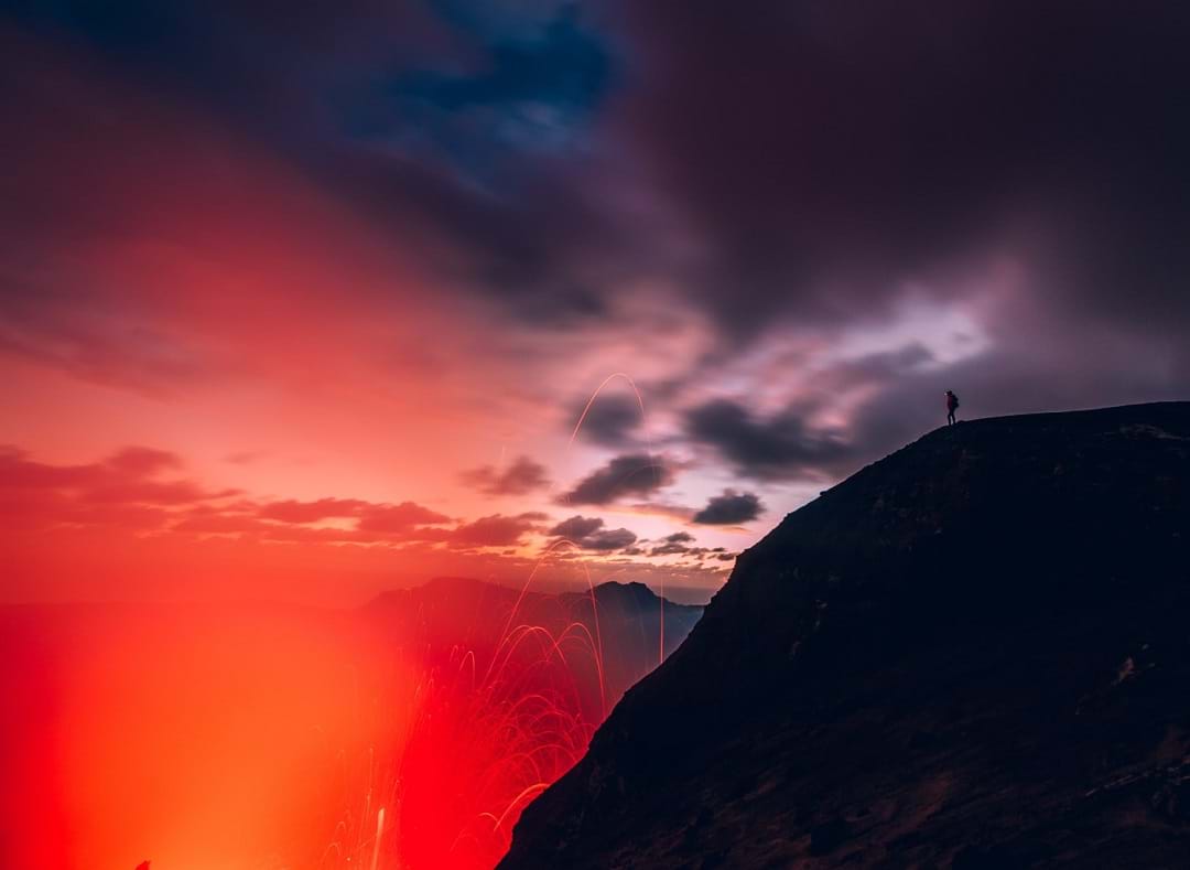 A person looking into an active volcano, Mt Yasur