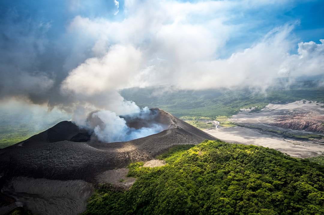 A wide shot of My Yasur volcano during the day